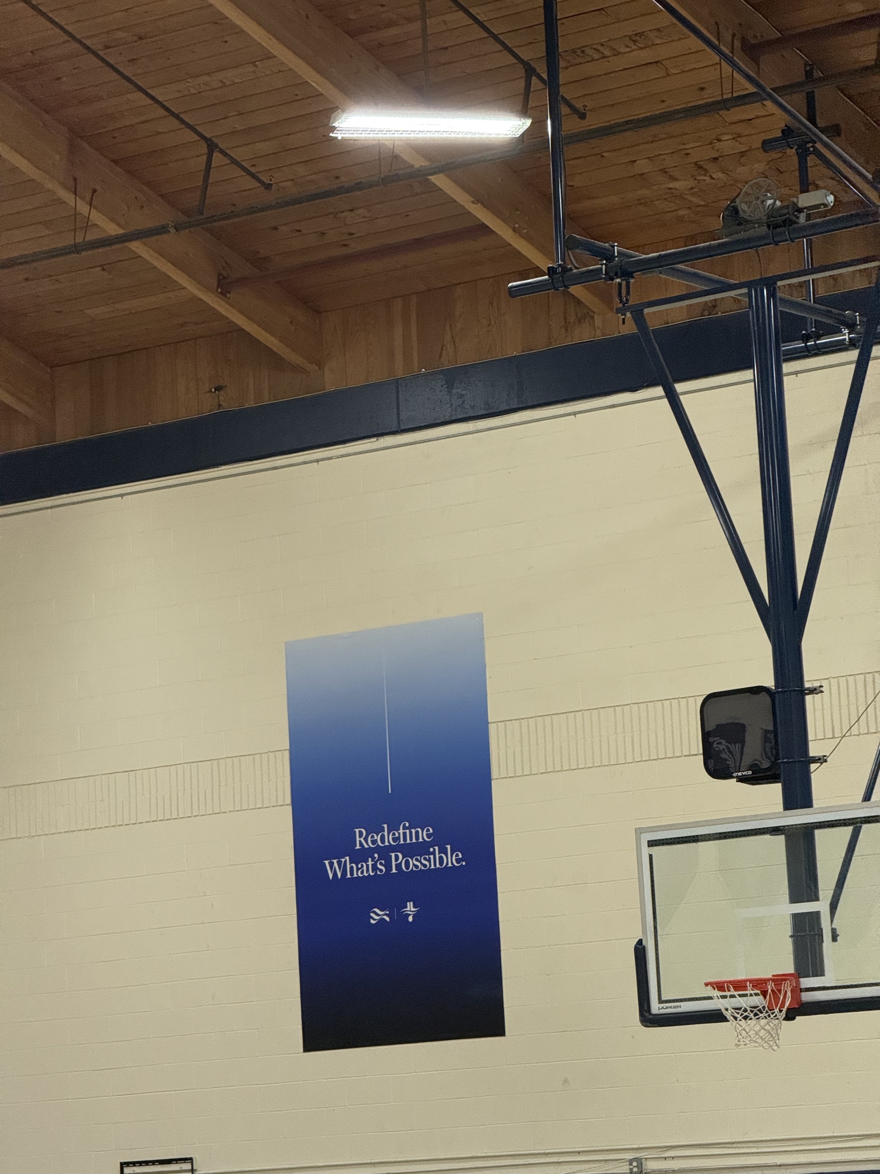 JLIN NextGen banner inside the camp gym